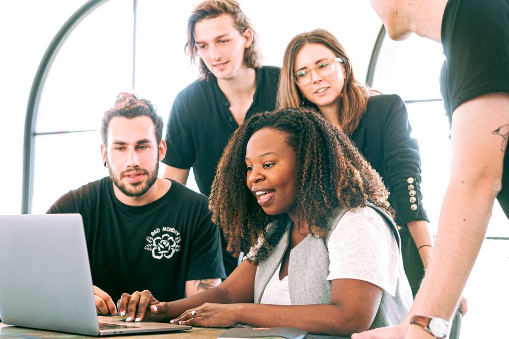 A group of employees at a computer.