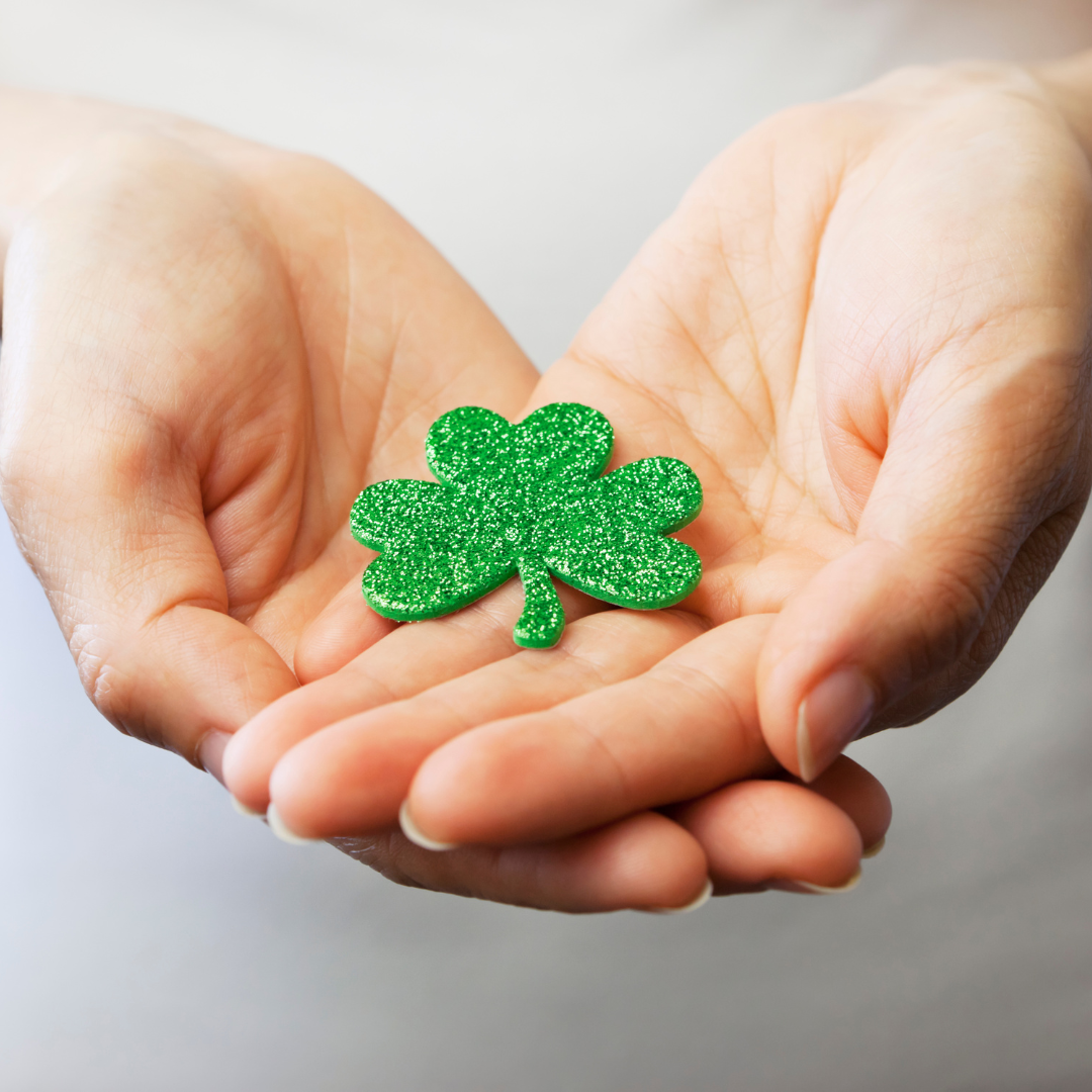 The Luck of the irish depicted here with someone holding a four leaf clover in their hands