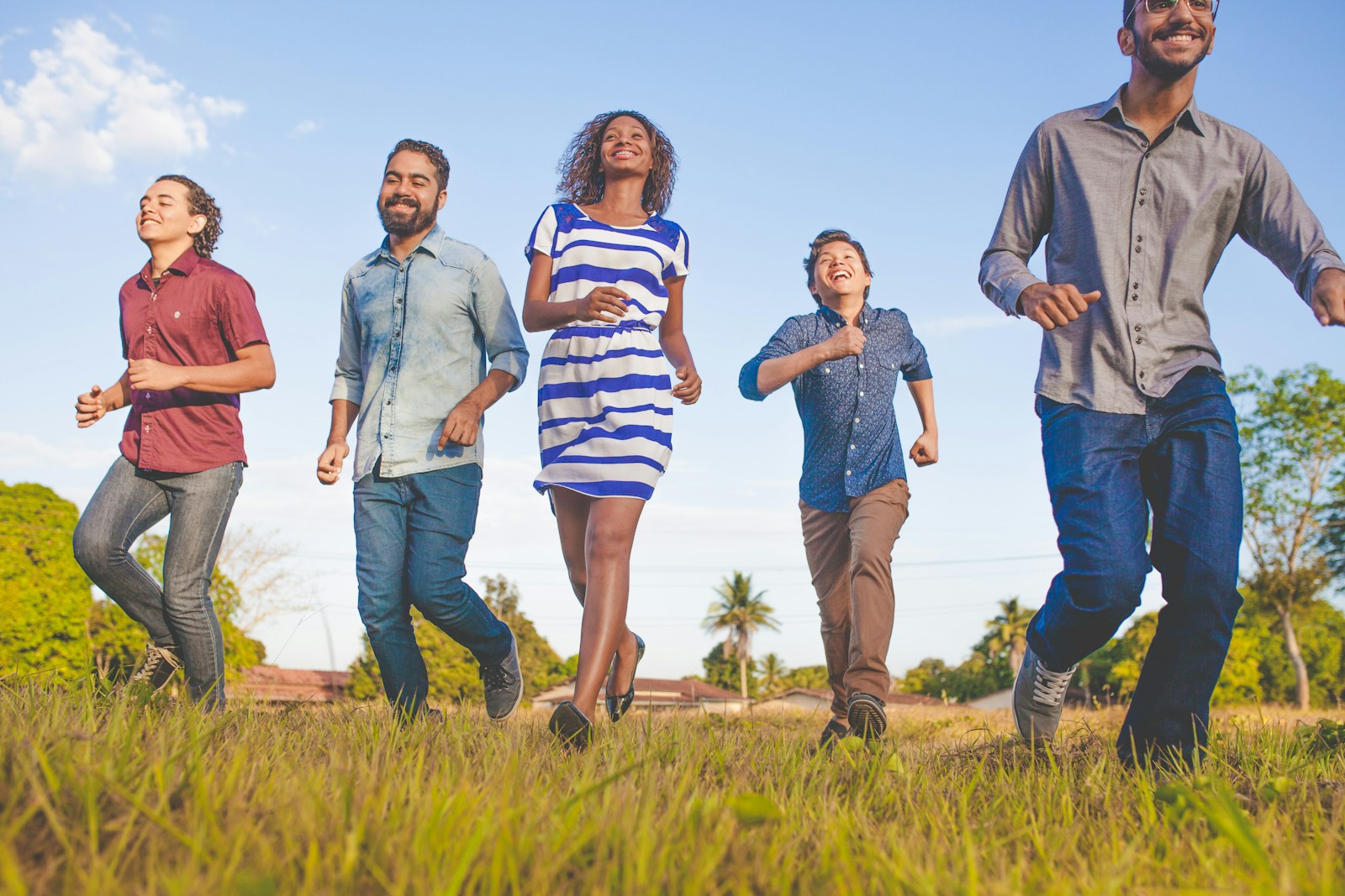 people running on grassfield under blue skies at daytime Environmental, Social and Governance