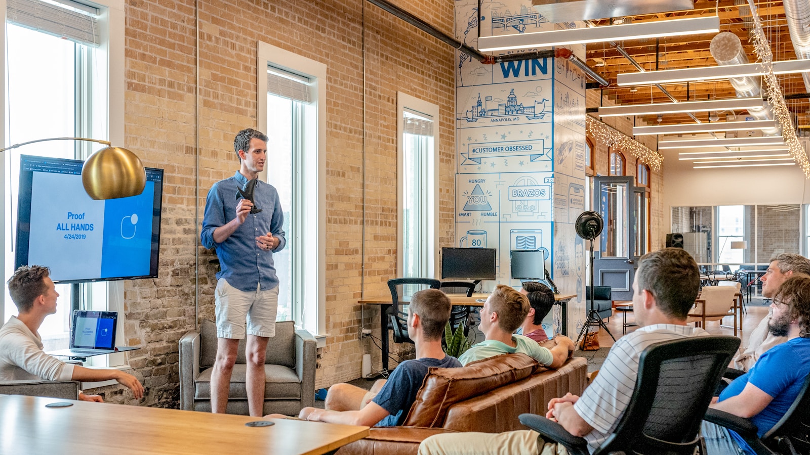 man standing in front of group of men Training and Development of Your Employees