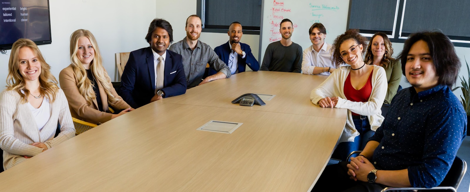 group of people employees sitting on chair in front of brown wooden table