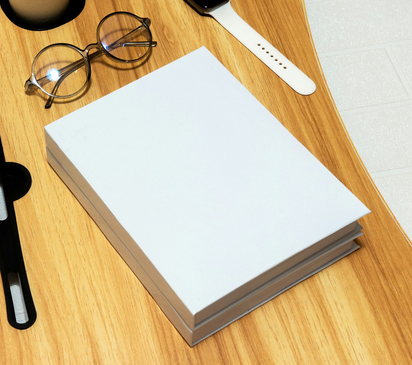 a wooden table topped with glasses and a book